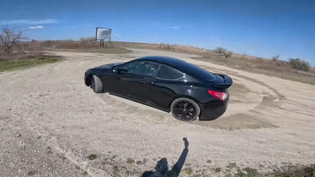 Hyundai Genesis Coupe doing donuts on sand